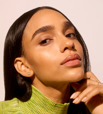 Woman close-up focusing on Even, glowing, hydrated skin thanks to Acure's skincare routines